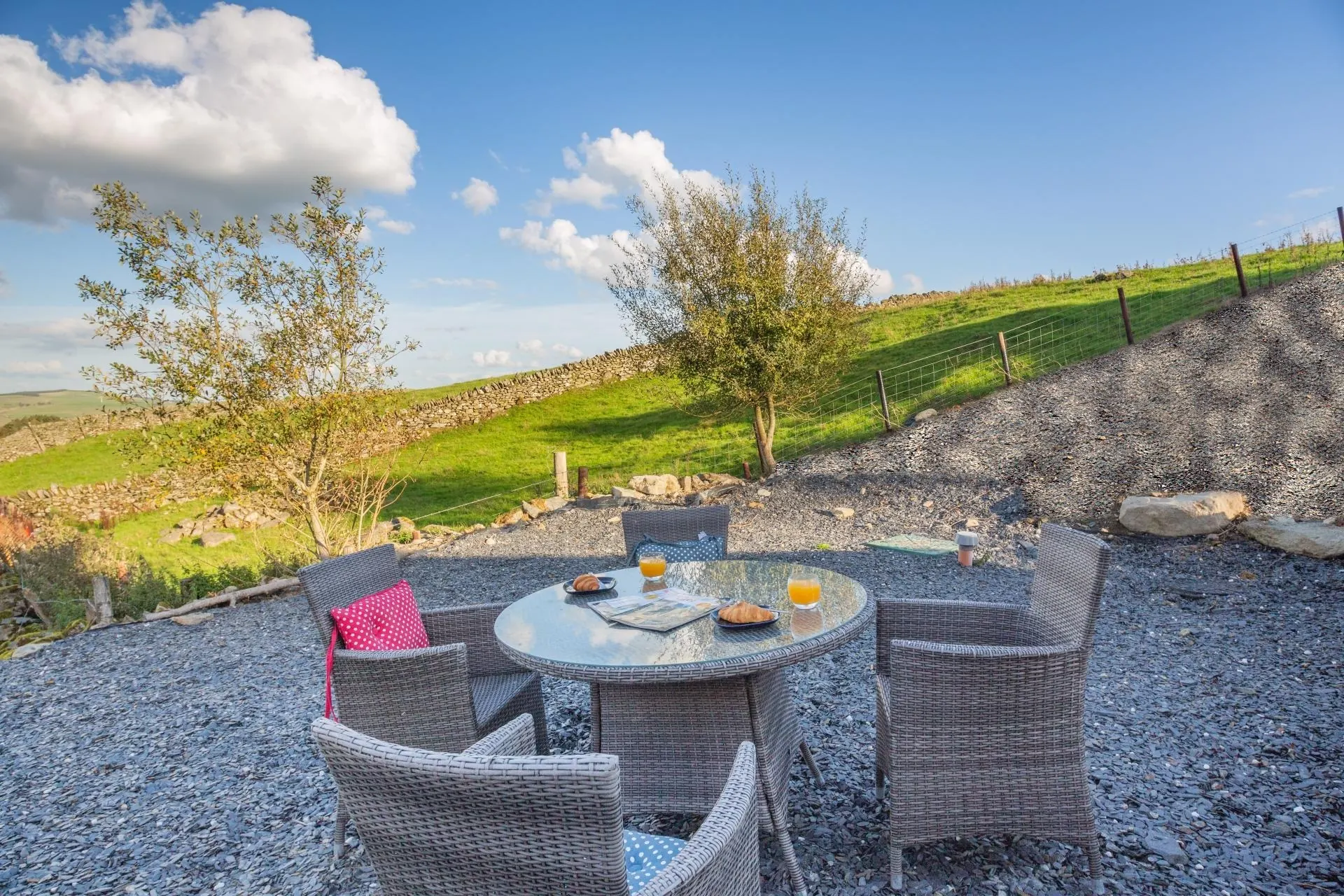 Private terrace with outdoor seating overlooking rolling Welsh hills
