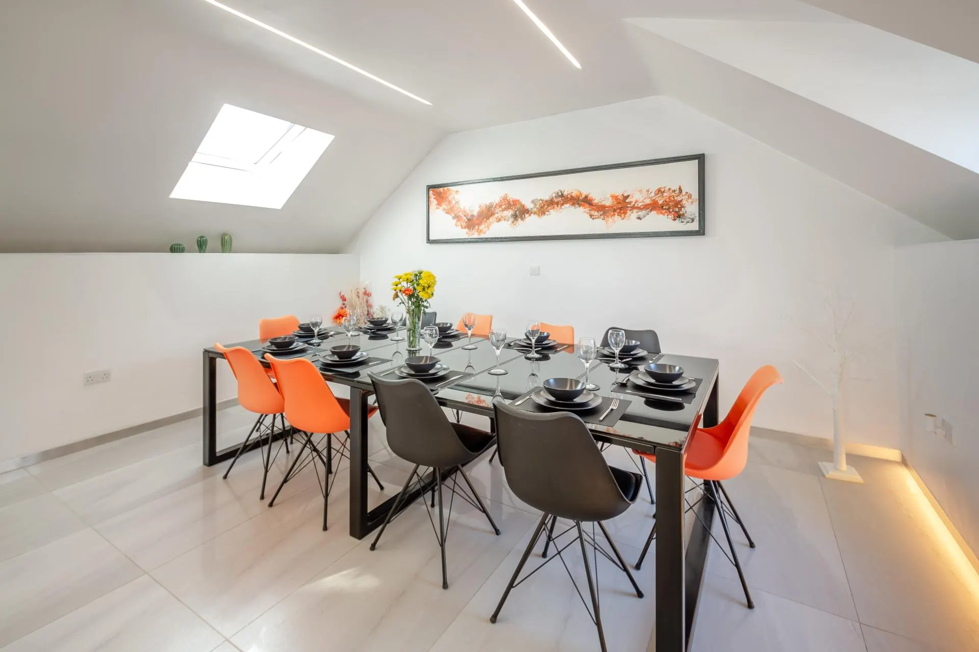 Dining table set for ten beneath a vaulted ceiling
