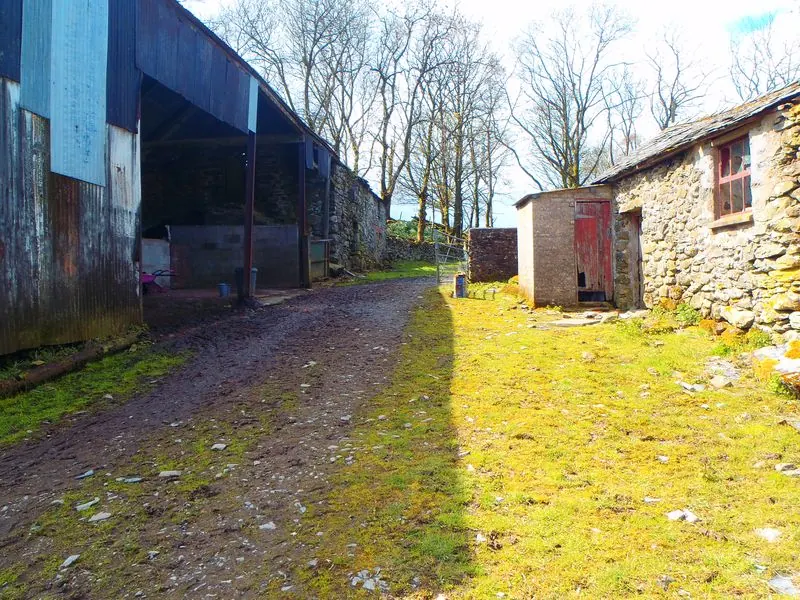 The farmyard track between the working buildings.
